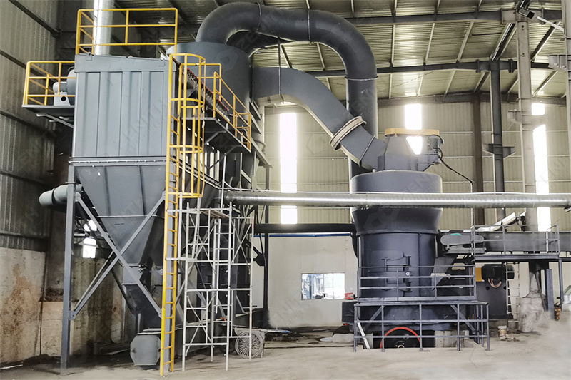 Technician performing maintenance on grinding mill