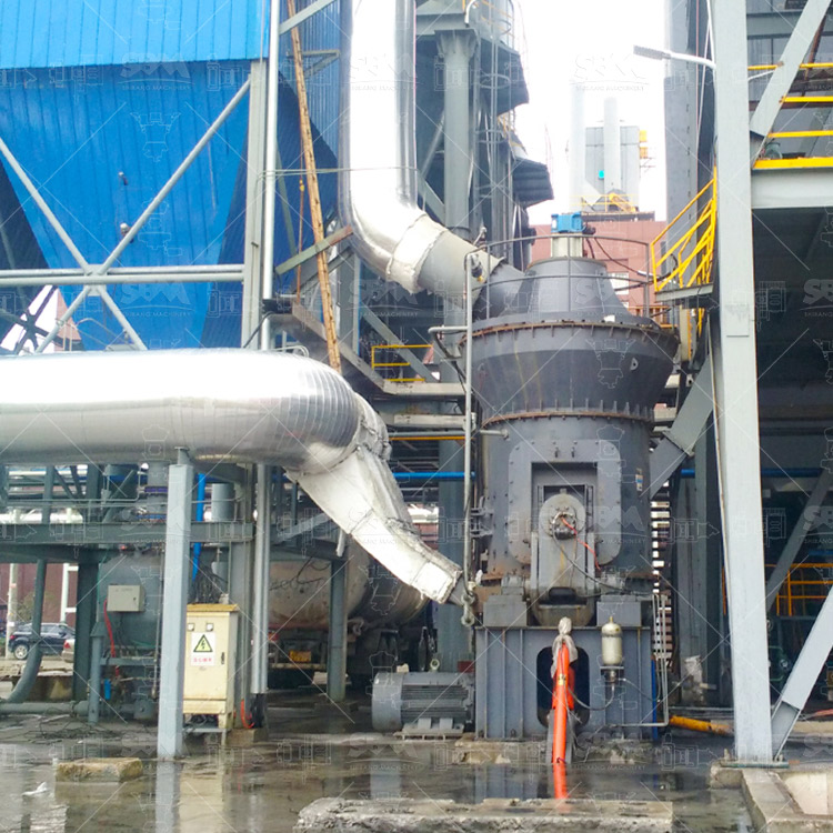 Workers assembling a coal grinding mill