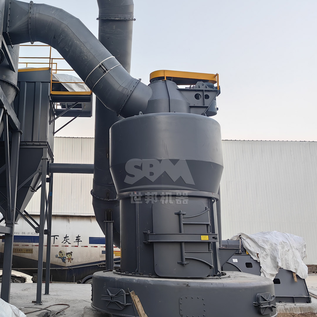A large MTW Series European Trapezium Mill installed in an industrial mineral processing plant.