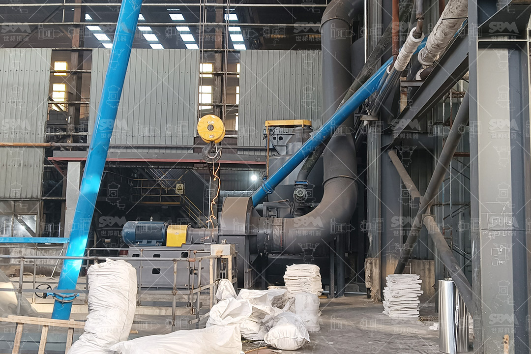 Operator monitoring the automated control system of a grinding mill circuit in an industrial setting.