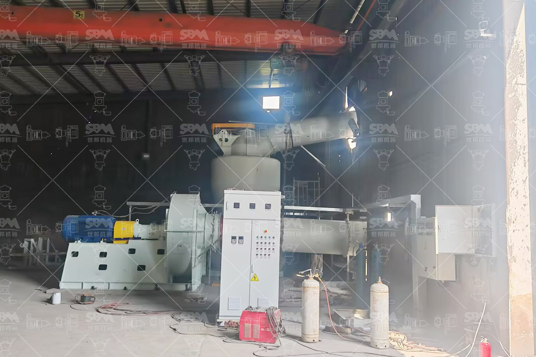 Overview of a large industrial powder plant with heavy machinery for mineral processing